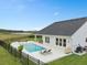 Backyard pool with jacuzzi, lounge chairs, and an outdoor seating area attached to a white-sided home at 3135 Vanguard Ct, St Cloud, FL 34771