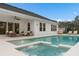 Backyard pool and jacuzzi with an outdoor seating area attached to a white-sided home at 3135 Vanguard Ct, St Cloud, FL 34771