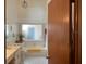 Well-lit bathroom with a bathtub, a toilet, and a vanity with a light-colored countertop at 3210 Little Oak Way, Orlando, FL 32812