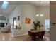 Dining area featuring vaulted ceilings, modern chandelier and bright natural lighting at 3210 Little Oak Way, Orlando, FL 32812