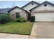 Charming single-story home with well-manicured lawn and an attached two-car garage at 3210 Little Oak Way, Orlando, FL 32812