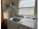 Bright laundry room featuring modern Samsung washer and dryer, plus storage shelf at 3210 Little Oak Way, Orlando, FL 32812