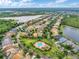 An aerial shot showcases the neighborhood with beautiful houses and a community pool near the lakes and green spaces at 3320 Ashmount Dr, Orlando, FL 32828