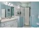 Well-lit bathroom featuring a walk-in shower and sink with storage at 3320 Ashmount Dr, Orlando, FL 32828