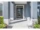 Close-up of a well-lit front door with decorative glass and white trim at 3320 Ashmount Dr, Orlando, FL 32828