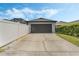 Detached two-car garage featuring a long driveway and well-maintained lawn at 3320 Ashmount Dr, Orlando, FL 32828