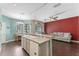 Open layout with modern kitchen island flowing into the living room with hardwood floors at 3320 Ashmount Dr, Orlando, FL 32828