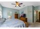 The bedroom features calming colors, a ceiling fan and a large dresser with TV at 3320 Ashmount Dr, Orlando, FL 32828