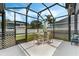 Relaxing screened-in patio with dining set, outdoor seating, and views of the fenced yard at 3320 Ashmount Dr, Orlando, FL 32828