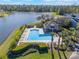 A lovely community pool and lake, with a covered area and ample lounge chairs for residents to relax and enjoy the view at 3320 Ashmount Dr, Orlando, FL 32828