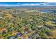 Aerial view of a secluded home with a large surrounding forest and neighboring communities in the distance at 3443 Players Point Loop, Apopka, FL 32712