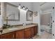 Bathroom featuring granite countertops, dual sinks, modern fixtures, and a separate toilet and shower at 3443 Players Point Loop, Apopka, FL 32712