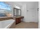 Bright bathroom with a tub, a granite countertop vanity, and a window providing natural light at 3443 Players Point Loop, Apopka, FL 32712