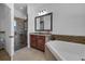 Bathroom featuring tub, shower, and vanity with stylish decorative mirror at 3443 Players Point Loop, Apopka, FL 32712