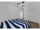 Bedroom with wood-look floors, ceiling fan, closet, and a blue comforter on the bed at 3443 Players Point Loop, Apopka, FL 32712