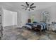 Bright bedroom featuring tile floors, arched windows, and a ceiling fan at 3443 Players Point Loop, Apopka, FL 32712