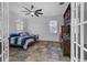 Bedroom featuring tile floors, a ceiling fan, and double doors for entry at 3443 Players Point Loop, Apopka, FL 32712