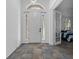 Foyer featuring decorative tiling, a front door with sidelights, and an open doorway at 3443 Players Point Loop, Apopka, FL 32712