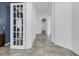 Hallway with decorative tiling that leads past an office with a large grid-patterned glass door at 3443 Players Point Loop, Apopka, FL 32712