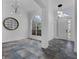 Living room featuring decorative tiling, an accent wall, and an arched window at 3443 Players Point Loop, Apopka, FL 32712