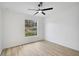 A clean bedroom features modern flooring, paint, and a window overlooking a quiet street at 3722 Madbury Cir, Lakeland, FL 33810