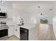 Bright kitchen featuring white cabinets, stainless steel appliances, and modern pendant lighting at 3722 Madbury Cir, Lakeland, FL 33810