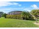 Beautiful backyard features a lush green lawn and manicured hedges, creating a private outdoor space at 4068 Stone Creek Loop, Lake Wales, FL 33859