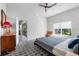 Bedroom with blue comforter, dresser, and large window offering natural light at 4068 Stone Creek Loop, Lake Wales, FL 33859