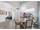 Dining room with view to the front door and a modern light fixture at 4068 Stone Creek Loop, Lake Wales, FL 33859