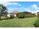 The home's exterior showcases mature landscaping and a screened-in lanai, offering picturesque outdoor living at 4068 Stone Creek Loop, Lake Wales, FL 33859