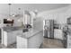 Modern kitchen with granite countertops, stainless steel appliances, and white cabinetry at 4068 Stone Creek Loop, Lake Wales, FL 33859