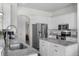 Bright kitchen with stainless steel appliances, granite countertops, and white cabinets at 4068 Stone Creek Loop, Lake Wales, FL 33859