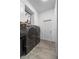 Modern laundry room with grey washer and dryer with white cabinets at 4068 Stone Creek Loop, Lake Wales, FL 33859