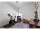 Bright living room with an exercise bike, blue chair, and area rug at 4068 Stone Creek Loop, Lake Wales, FL 33859