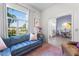 Bright living room with a blue sofa, large window overlooking the front yard, and view into the dining area at 4068 Stone Creek Loop, Lake Wales, FL 33859