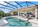 Enclosed pool area featuring a pool, lounge chairs, and an outdoor bar with great natural lighting at 4068 Stone Creek Loop, Lake Wales, FL 33859