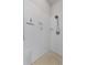 Bright white tiled shower features a shower head, bench, and recessed storage shelf at 4068 Stone Creek Loop, Lake Wales, FL 33859