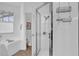 All-white bathroom featuring a glass-enclosed shower and a soaking tub at 408 Orista Dr, Davenport, FL 33897