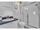 Bright bathroom featuring a glass-enclosed shower and a white vanity with a blue countertop at 408 Orista Dr, Davenport, FL 33897