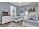 Charming Disney Frozen themed bedroom with twin beds, dresser, and a ceiling fan at 408 Orista Dr, Davenport, FL 33897