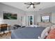 Relaxing bedroom area with a cozy chair, a desk, a ceiling fan, and modern furniture at 408 Orista Dr, Davenport, FL 33897