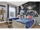 Star Wars themed bedroom with two twin beds, a ceiling fan, and creative wall art at 408 Orista Dr, Davenport, FL 33897