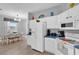 Bright eat-in kitchen featuring white cabinets, blue countertops, and stainless steel appliances at 408 Orista Dr, Davenport, FL 33897