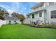 Rear exterior of home with manicured lawn and guest house at 415 W Rich Ave, Deland, FL 32720