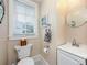 Bright powder room with white vanity, round mirror, and a window that provides natural light at 415 W Rich Ave, Deland, FL 32720