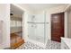 Modern bathroom with a glass walk-in shower featuring white subway tile and elegant mosaic flooring at 415 W Rich Ave, Deland, FL 32720