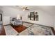 Attic bedroom with hardwood floors, rustic rugs, and bright overhead lighting at 415 W Rich Ave, Deland, FL 32720