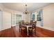 Formal dining room features beautiful hardwood floors, chandelier, and natural light at 415 W Rich Ave, Deland, FL 32720