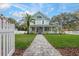 Charming two-story home featuring a welcoming front porch, manicured lawn, and classic architectural details at 415 W Rich Ave, Deland, FL 32720