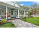 Inviting front porch with ceiling fans, decorated with potted plants, offering a relaxing outdoor space at 415 W Rich Ave, Deland, FL 32720